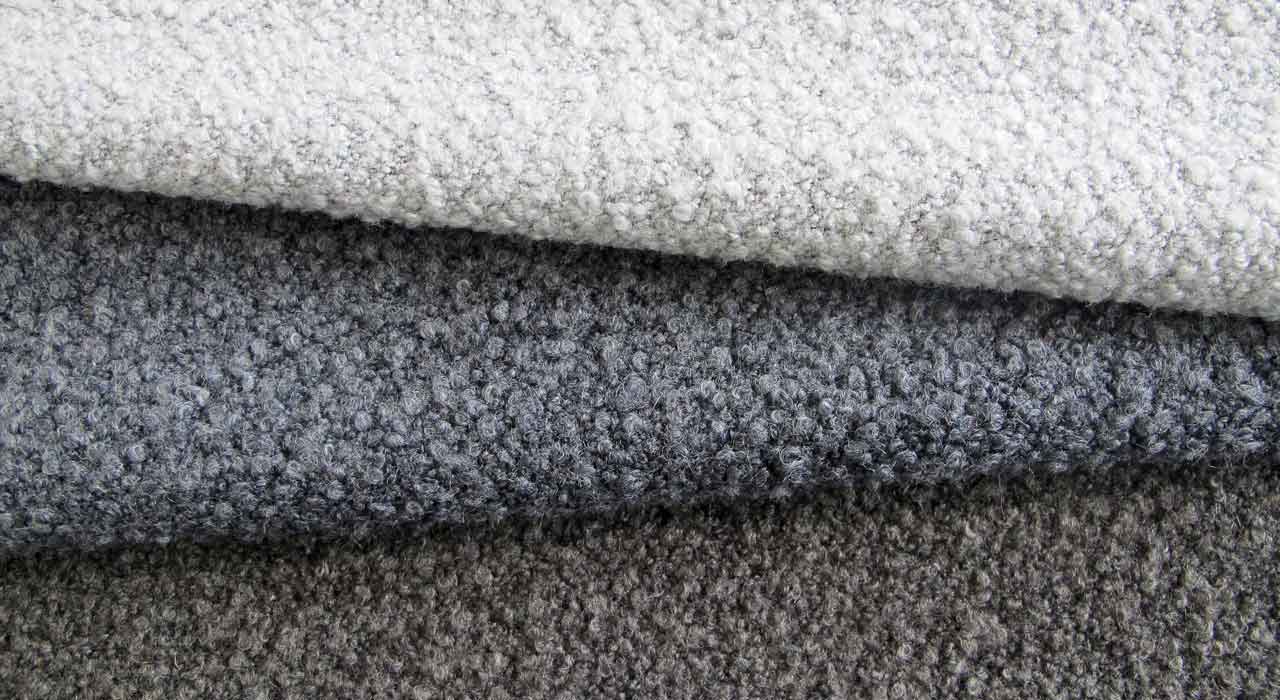 several boucle upholstery textiles laid on each other