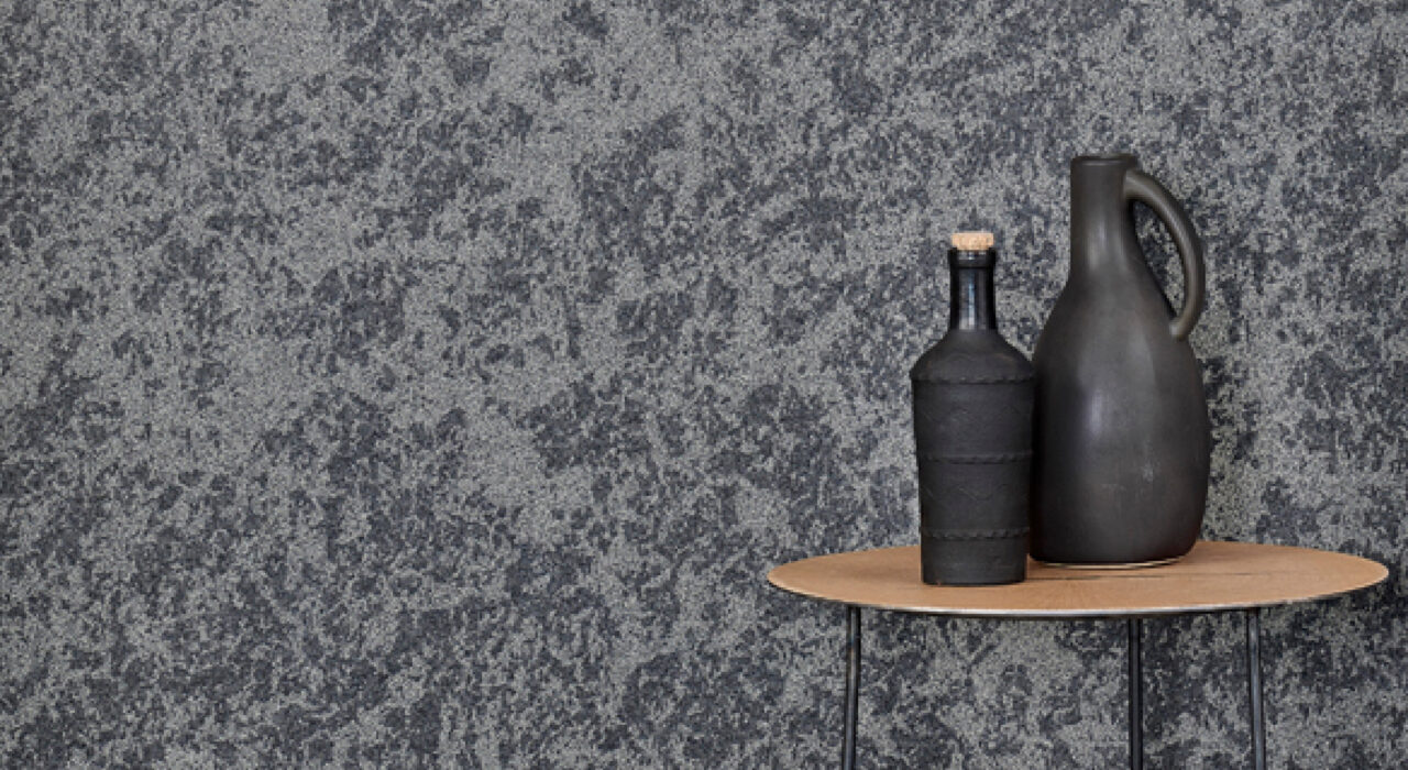 dark grey sound absorbing wall panel behind jars on a chair