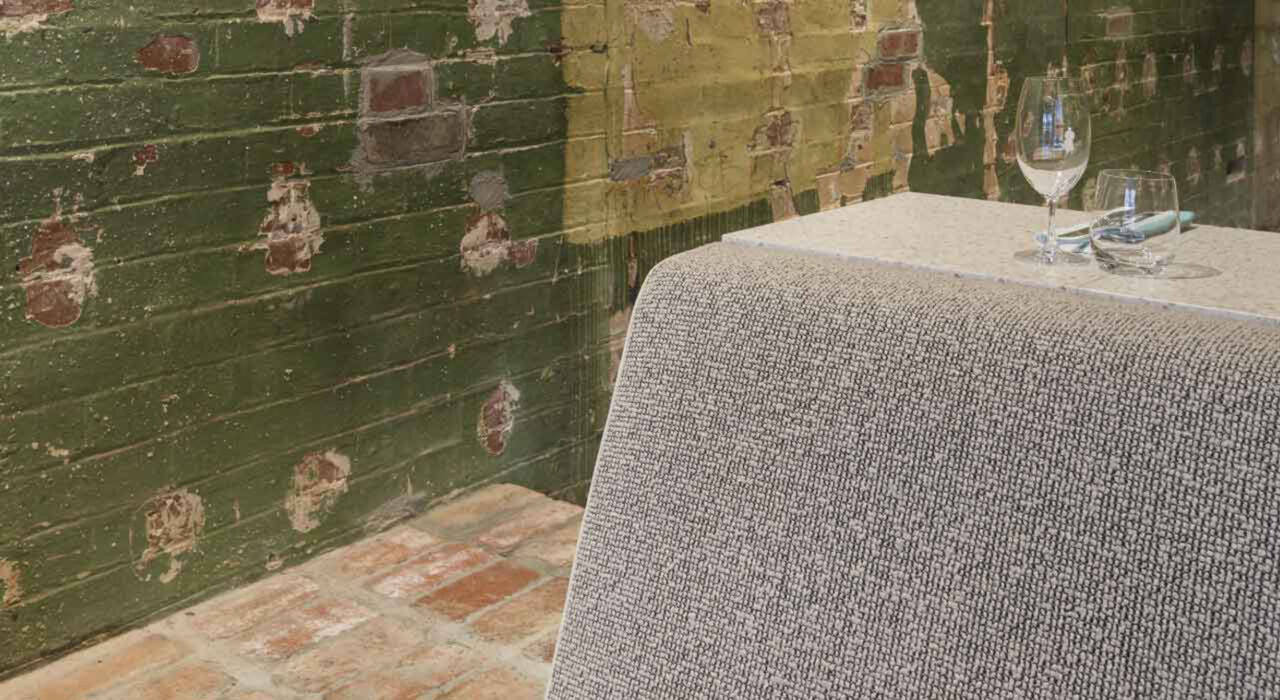 detail of a couch upholstered with a grey textile