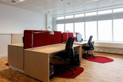 red wool felt rugs under desk chairs in an office