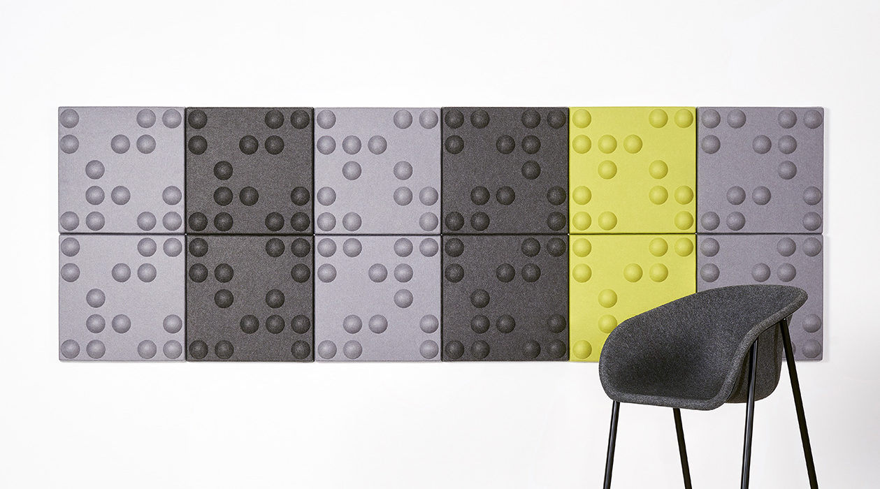 Installation featuring acoustic tile Ecoustic Bond Pewter Charcoal Lime tiles panels sound absorbing felt textile wall display chair