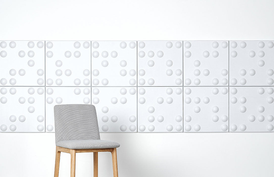 Installation featuring acoustic Ecoustic Bond White panels sound absorbing felt textile chair wall display