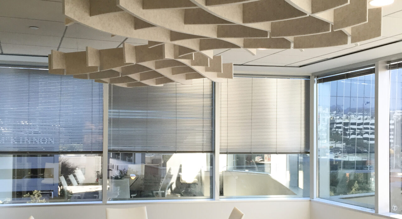 two sound absorbing baffles suspended above a conference room
