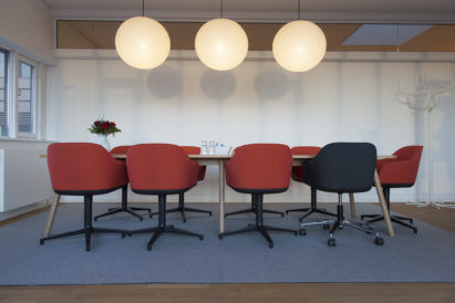 sound-absorbing felt rug under conference table and chairs in office