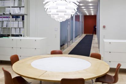 long dark grey wool felt rugs down office hallway seen from office