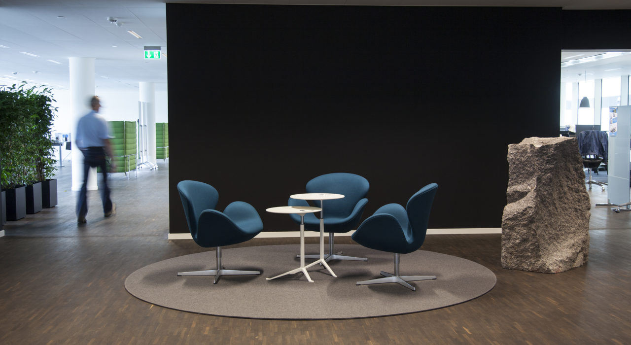 brown circular felt rug with seating in high traffic area