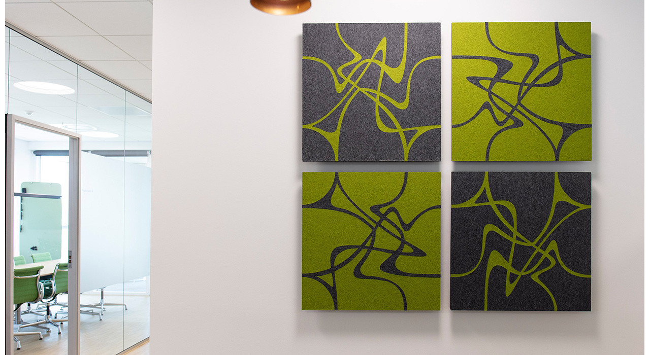 green and charcoal patterned acoustic wall tiles installed on office wall