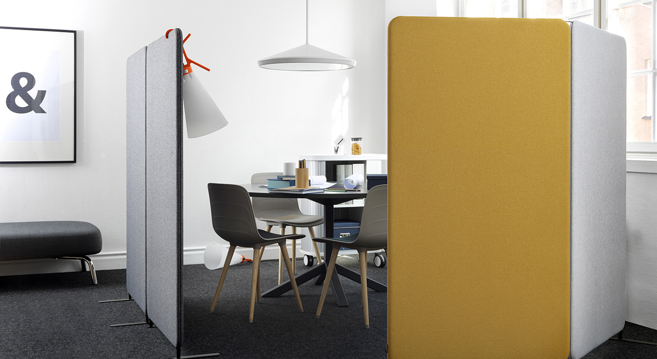 mustard yellow and white acoustic floor screens dividing an office lounge area