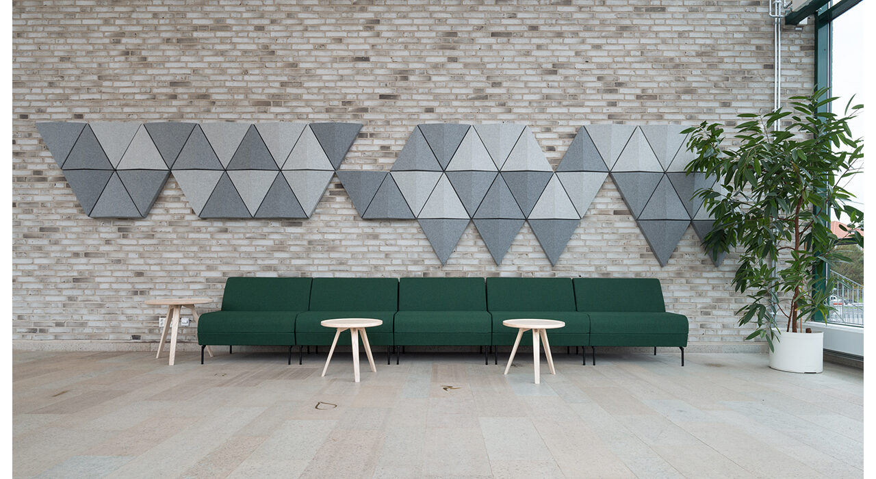 grey triangle sound absorbing tiles on brick wall