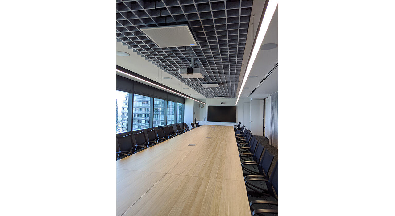 acoustic drop ceiling tiles in a large conference room above table chairs