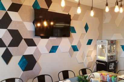 dark grey and off white hexagon shaped acoustic tiles on dining room wall