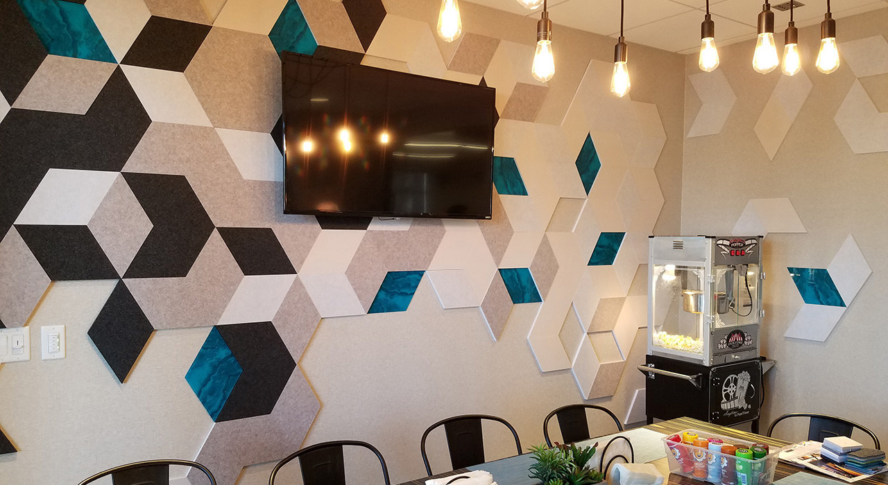 dark grey and off white hexagon shaped acoustic tiles on dining room wall