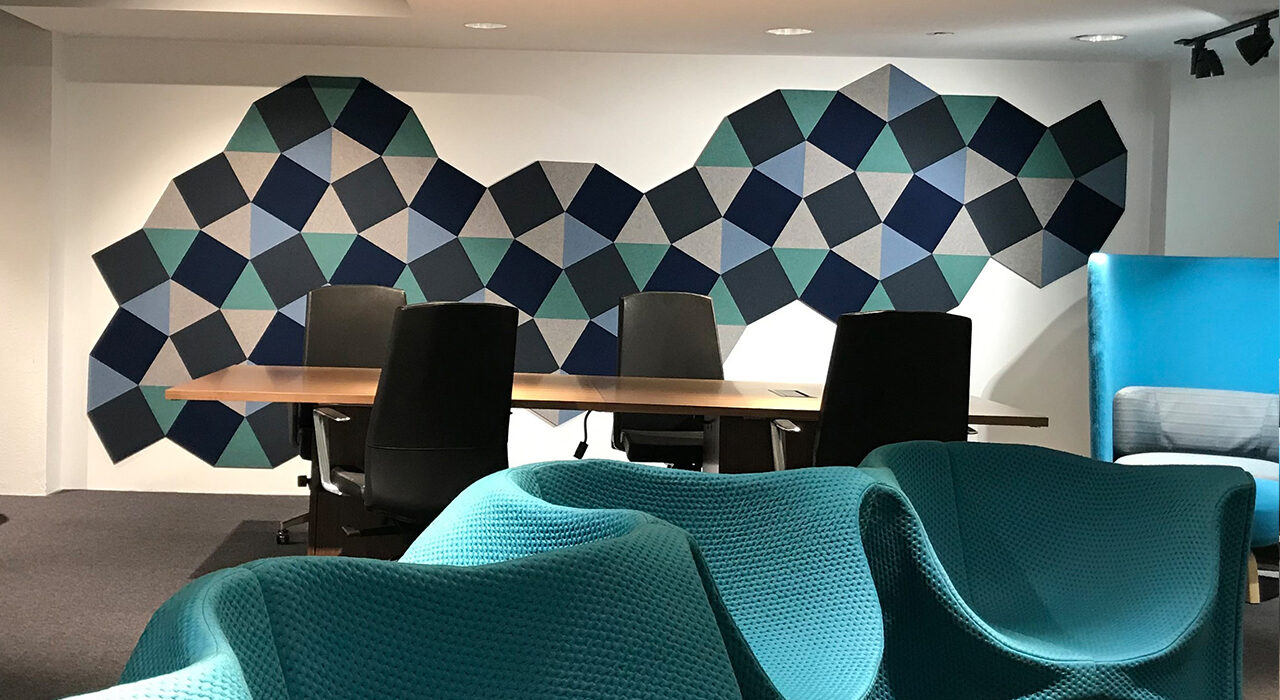 blue green and tan acoustic shapes on wall behind conference table