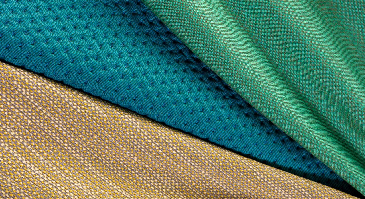 tan blue and green upholstery textiles folded