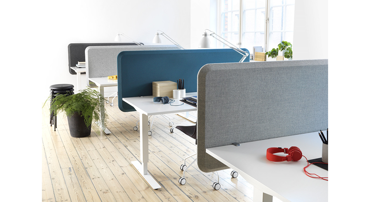 several colorful acoustic table screens on desks in office