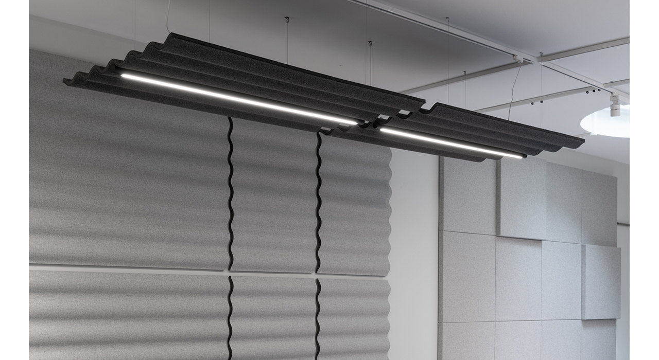 charcoal corrugated ceiling tile with lights suspended by wires