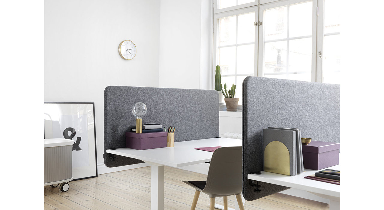 grey acoustic table screens on white desks with large window behind