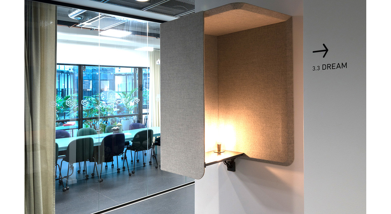 beige colored wall booth with light in a reception area