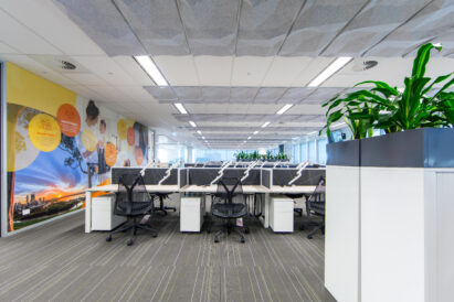 white ceiling tiles in office with desks and chairs