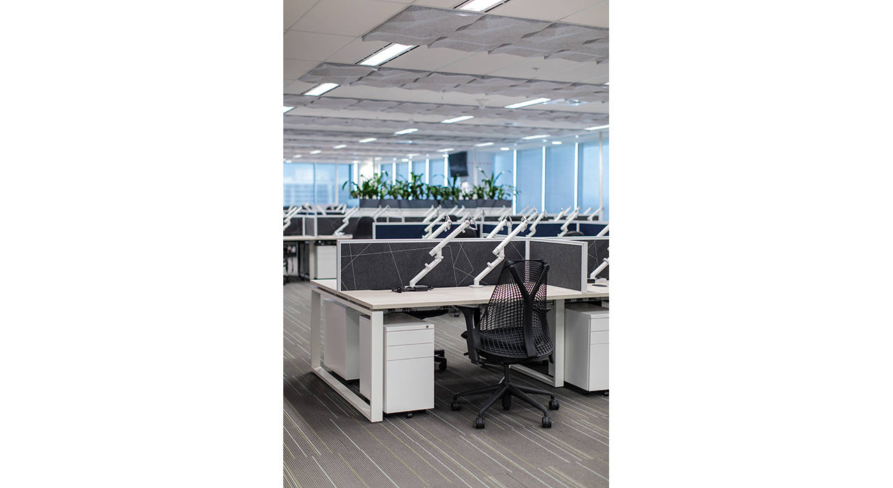white ceiling tiles in office with desks and chairs vertical