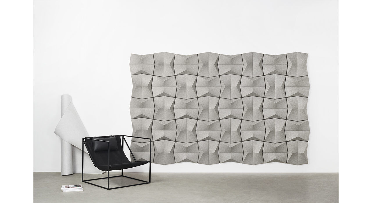 grey acoustic pinch wall tile with chair in front