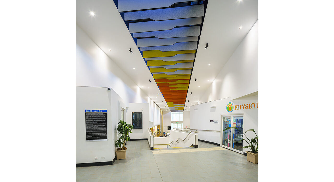 blue yellow and orange baffles above reception area