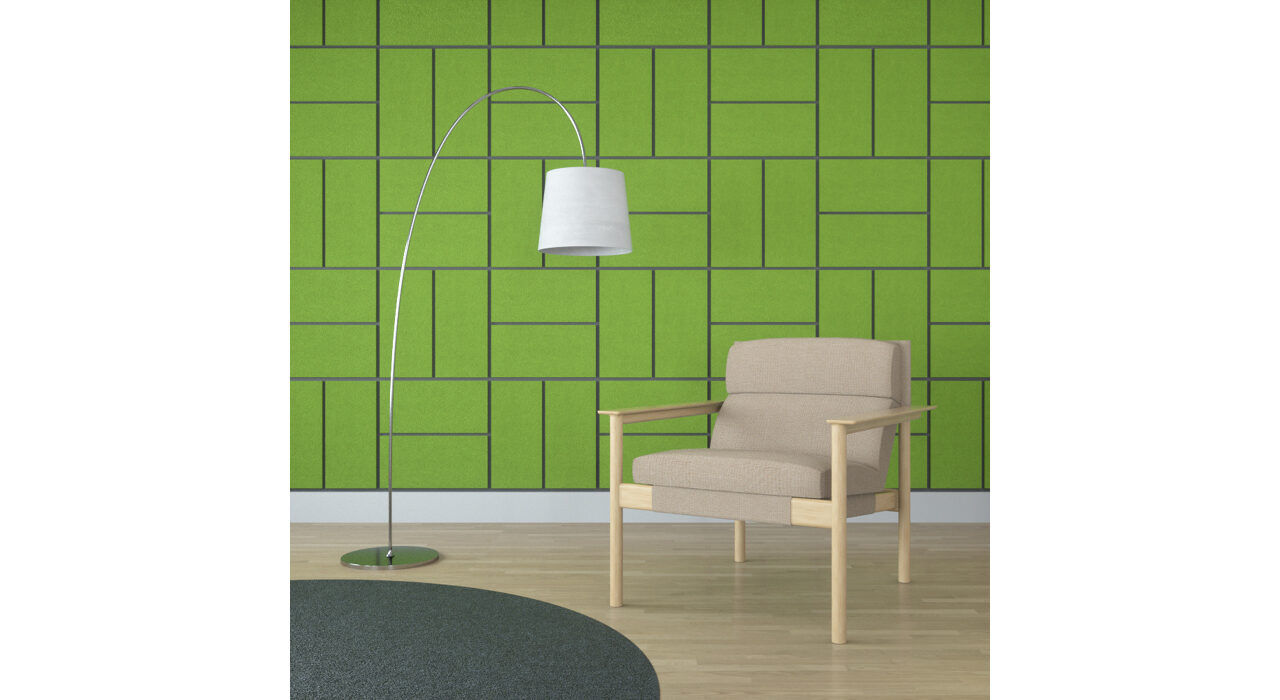 green rectangular shaped sound absorbing self stick tiles on wall behind chair