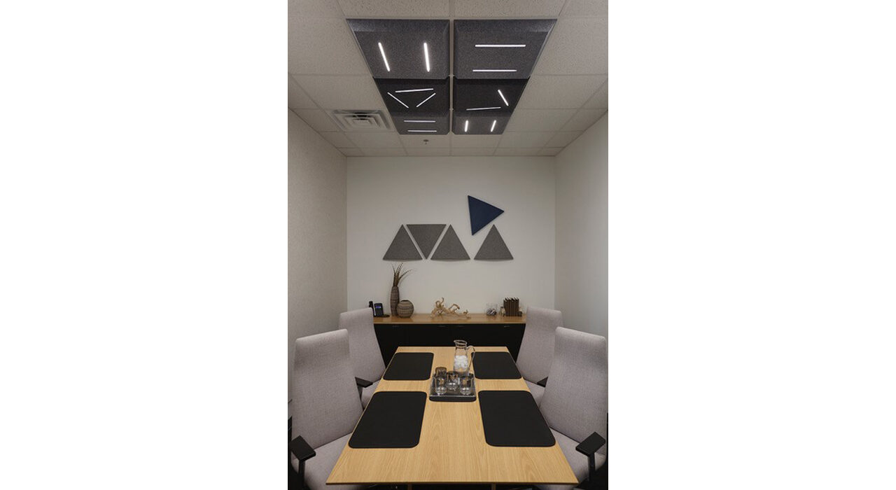 dark grey acoustic led tiles above conference room table