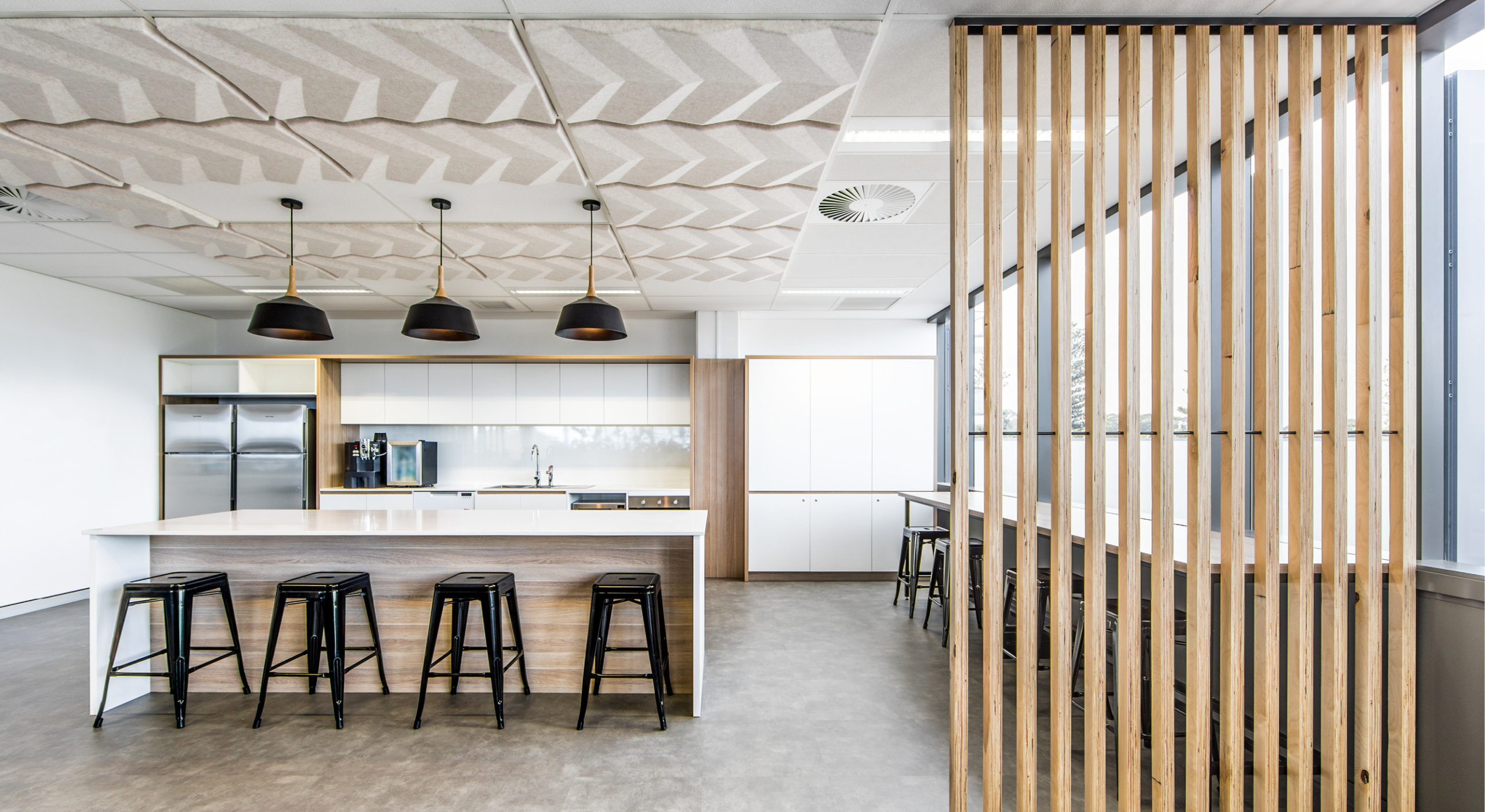 beige sound-absorbing ceiling tiles above kitchen area