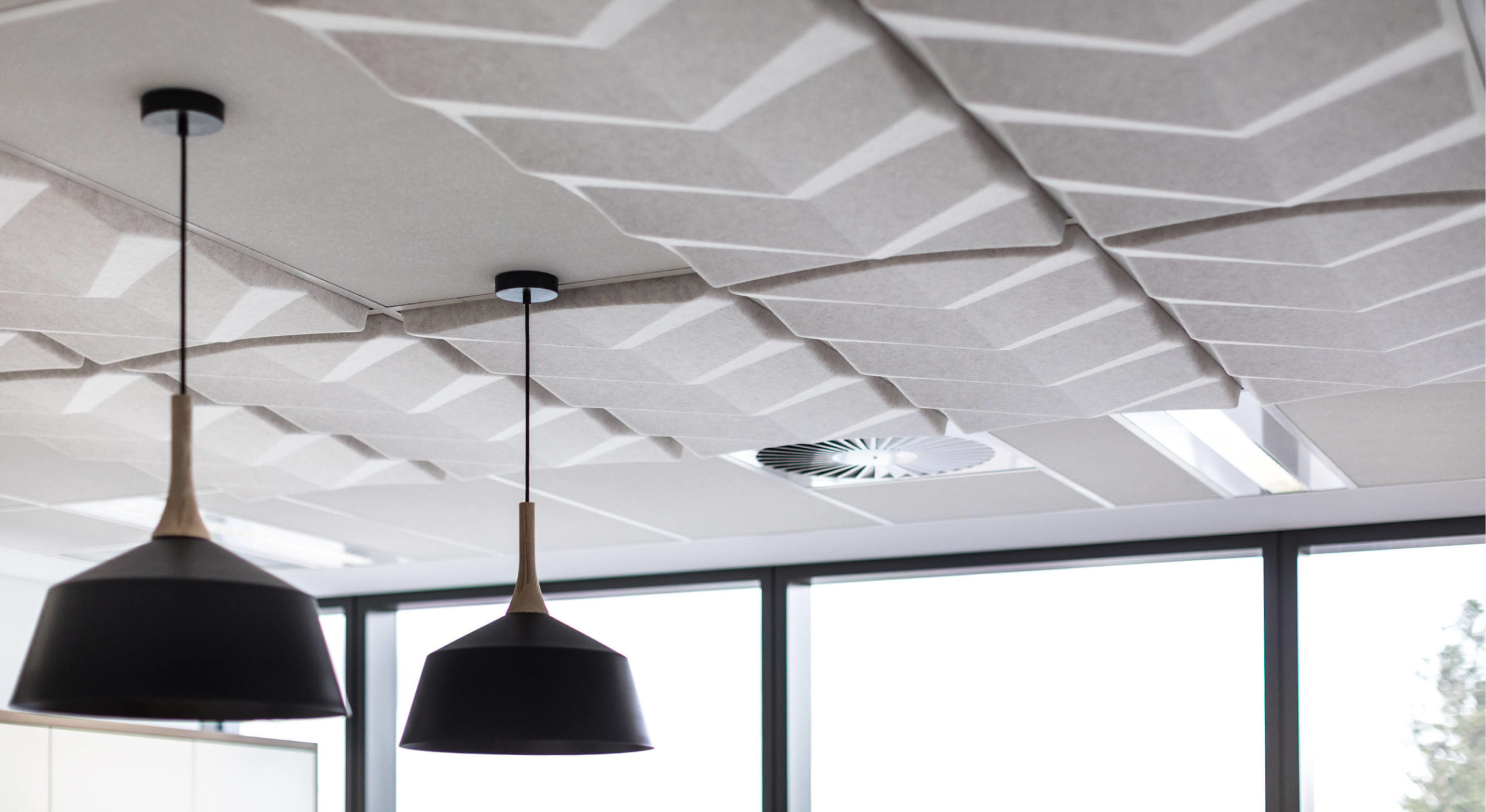beige sound-absorbing ceiling tiles with drop lights detail