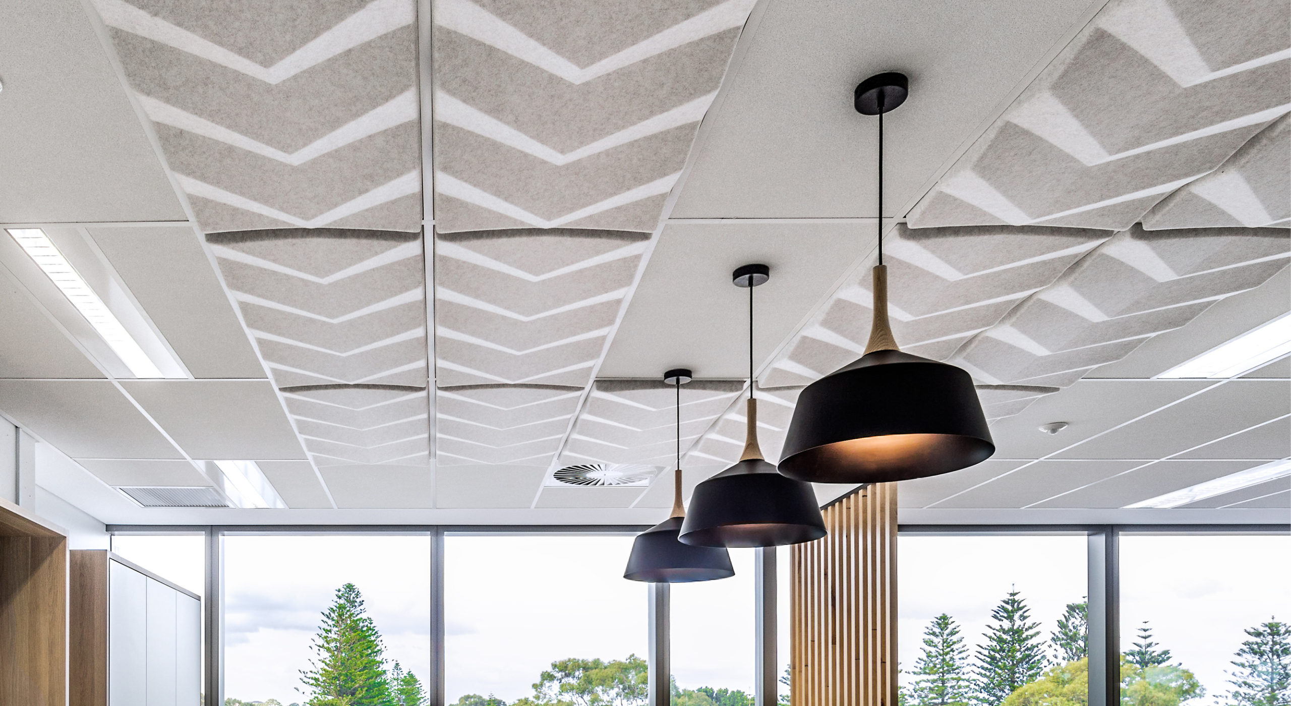 beige sound-absorbing ceiling tiles with drop lights and large window