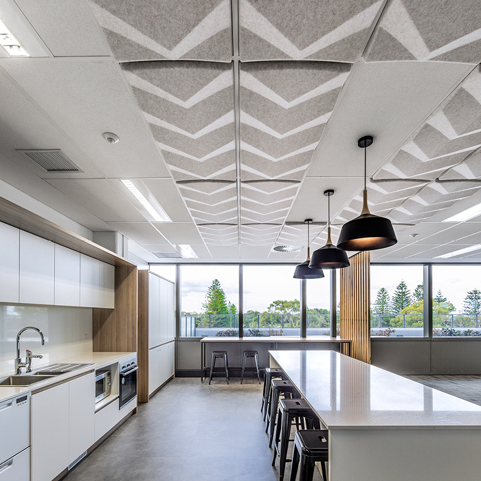 Ecoustic Torque beige sound-absorbing ceiling tiles above kitchen area