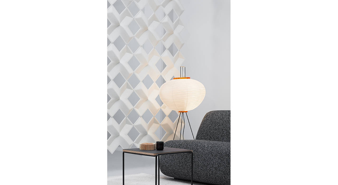 white sound absorbing air x tiles suspended behind sofa with lamp and table