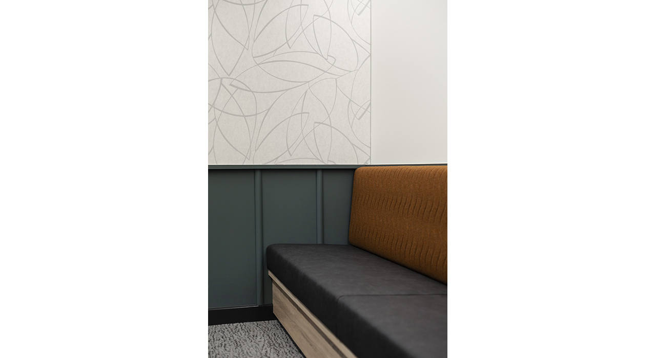 sound-absorbing wall panel with organic pattern near vinyl upholstered booth