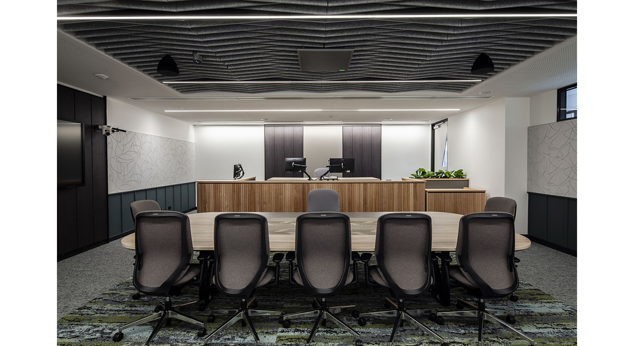 dark grey sound-absorbing drop ceiling tiles and wall panels in office boardroom