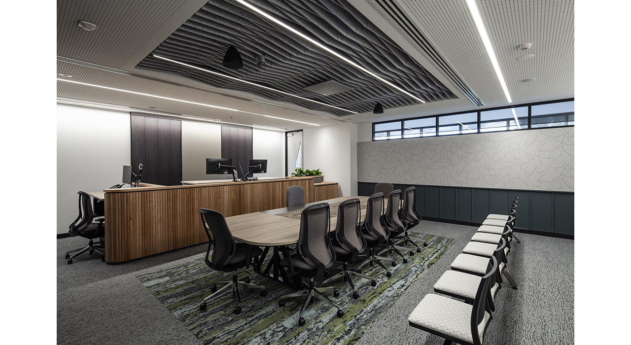 dark grey sound-absorbing drop ceiling tiles and wall panels in office boardroom