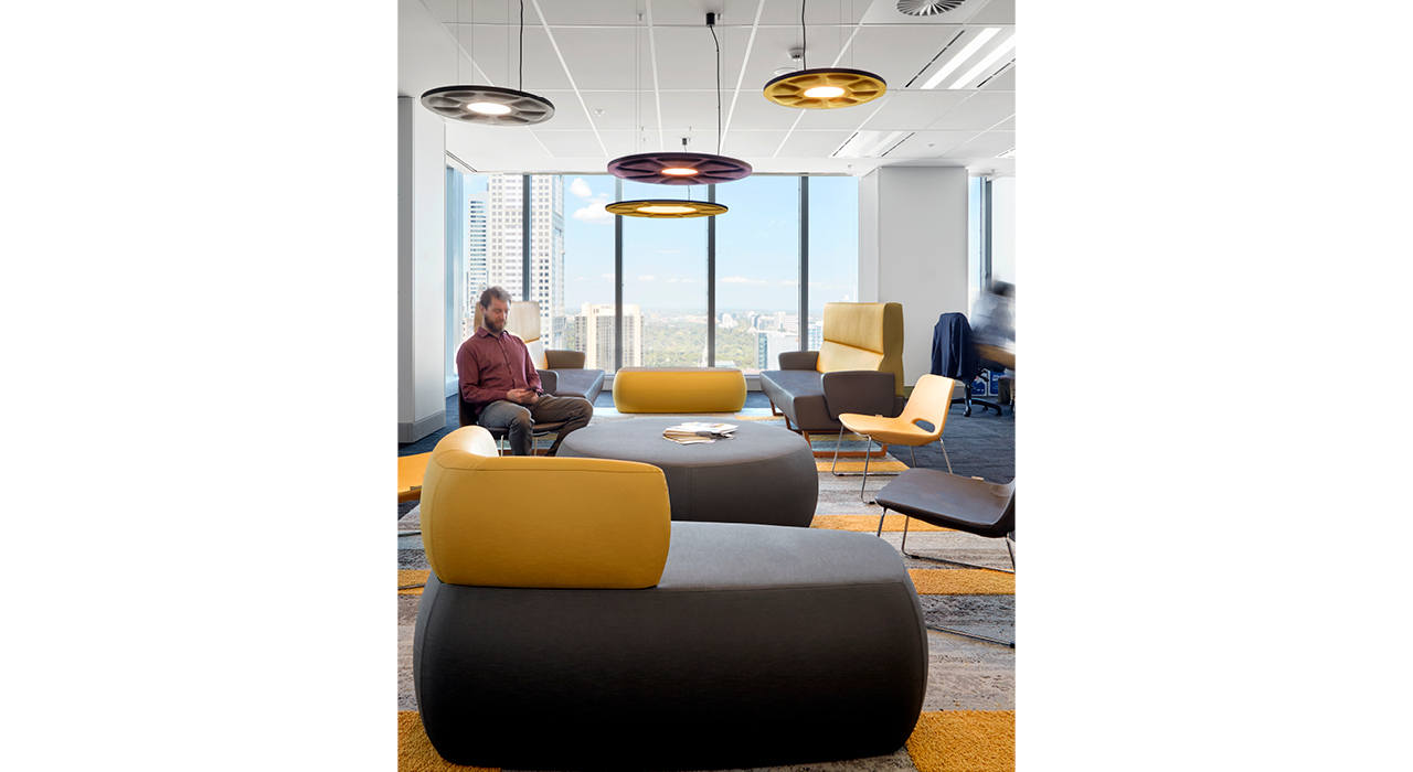 yellow and dark grey upholstery vinyl on sofas and ottomans in lounge area
