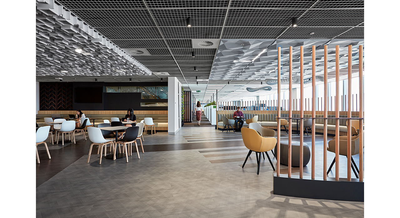 large lounge area with drop ceiling tiles in grid and sound-absorbing sculptural elements