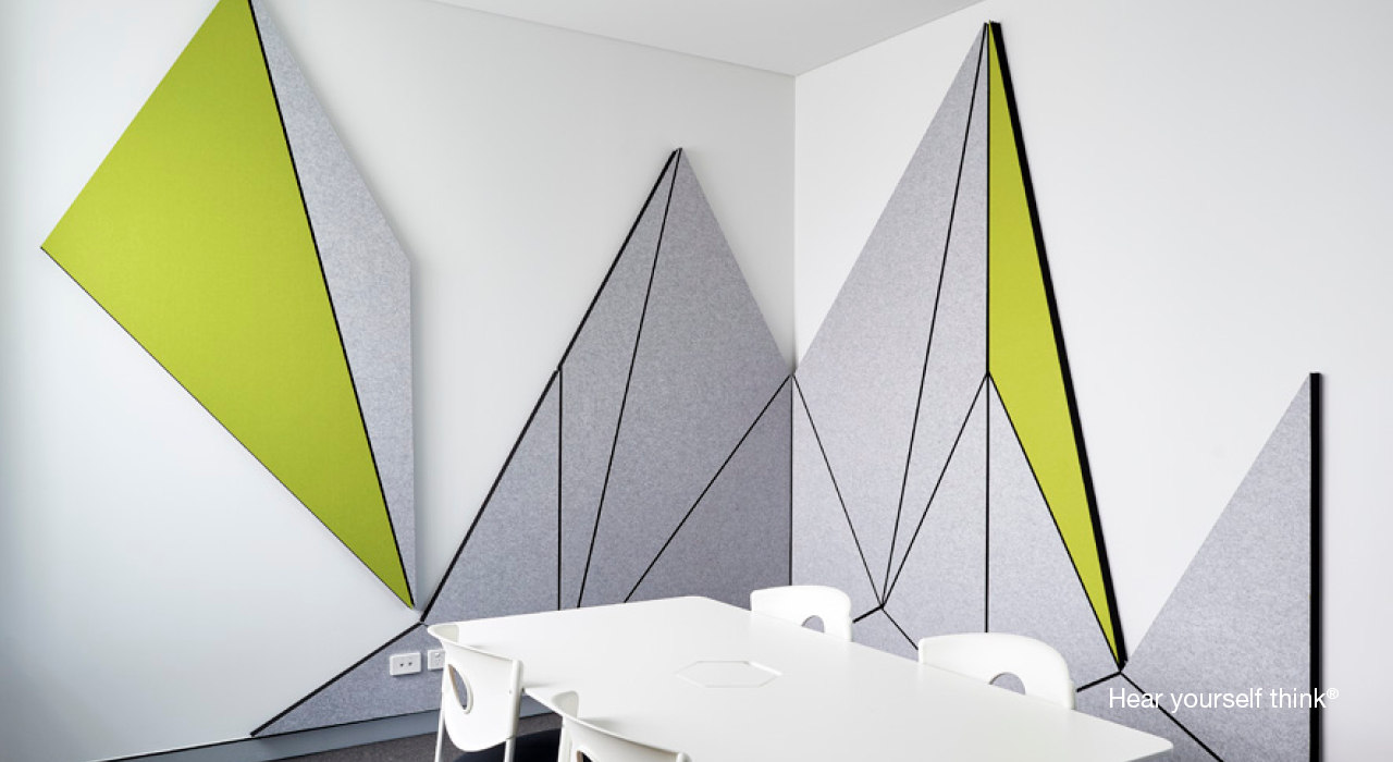green and grey acoustic panels cut into angular pieces on a wall