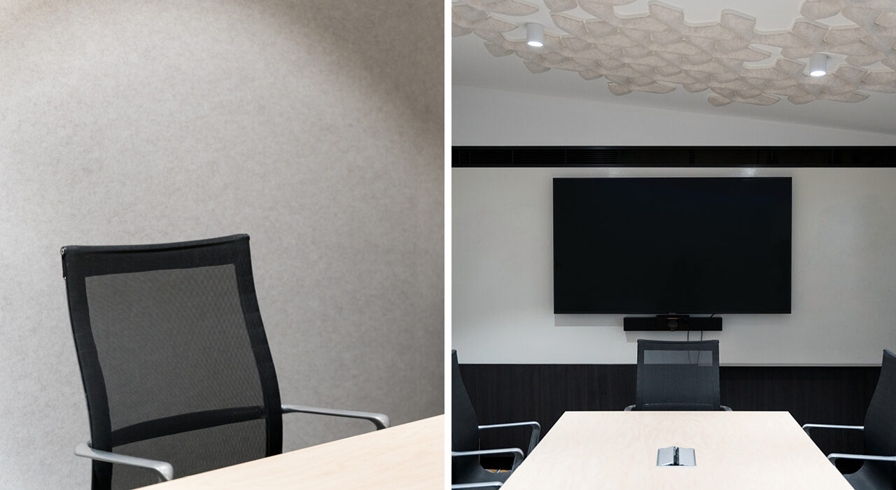 neutral acoustic panels and sound-absorbing tiles on office ceiling