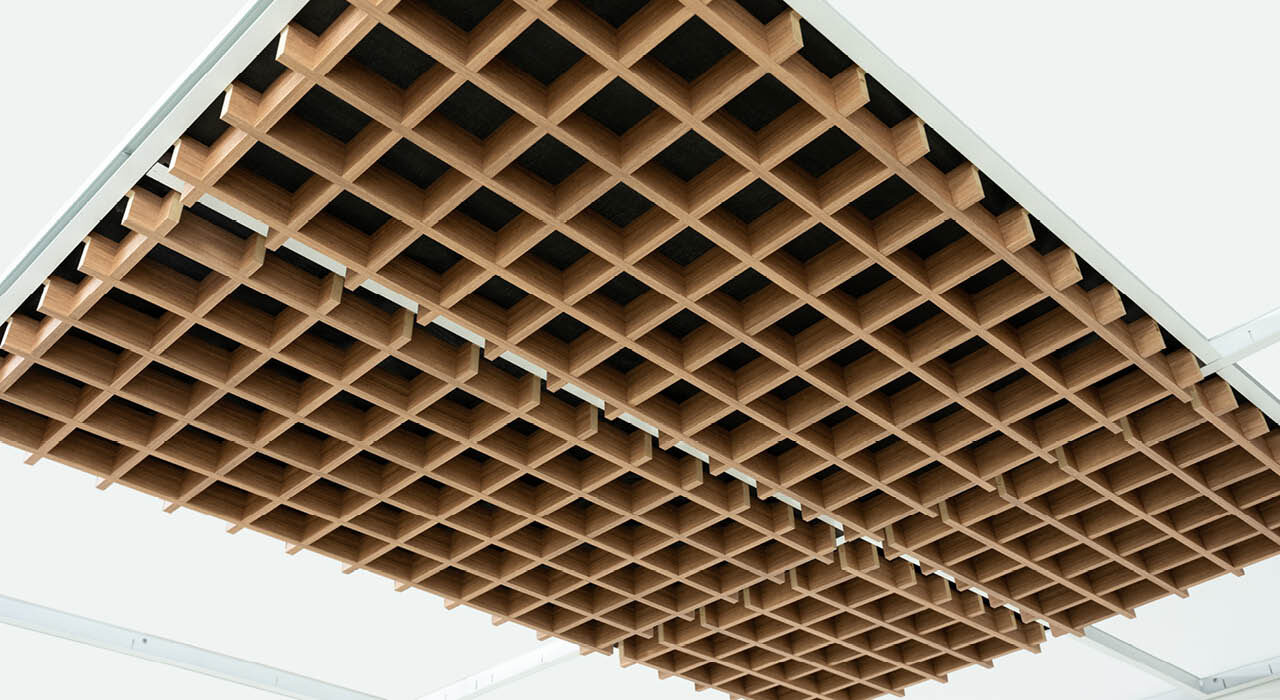 detail of an acoustic wooden drop ceiling tile with a square pattern reveal