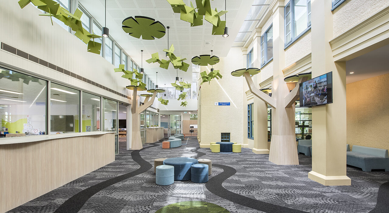 custom cut acoustic green panel floating above school lobby area