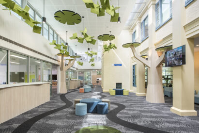 custom cut acoustic green panel floating above school lobby area