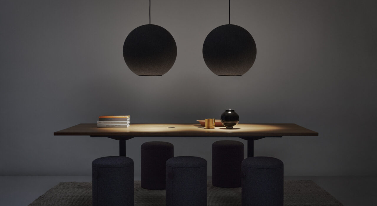 two globe shaped acoustic lamps above wooden table in dark room