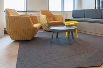 Custom cut Fraster Felt rug in Power Office under lounge seating